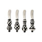 Four decorative knives with black and white patterned handles on a white background