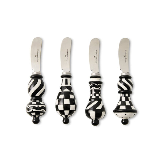 Four decorative knives with black and white patterned handles on a white background